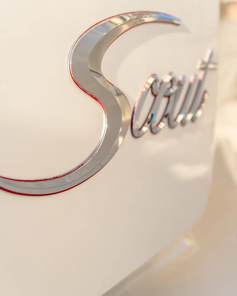 Mirror polished chrome Scout script on a clean white hull